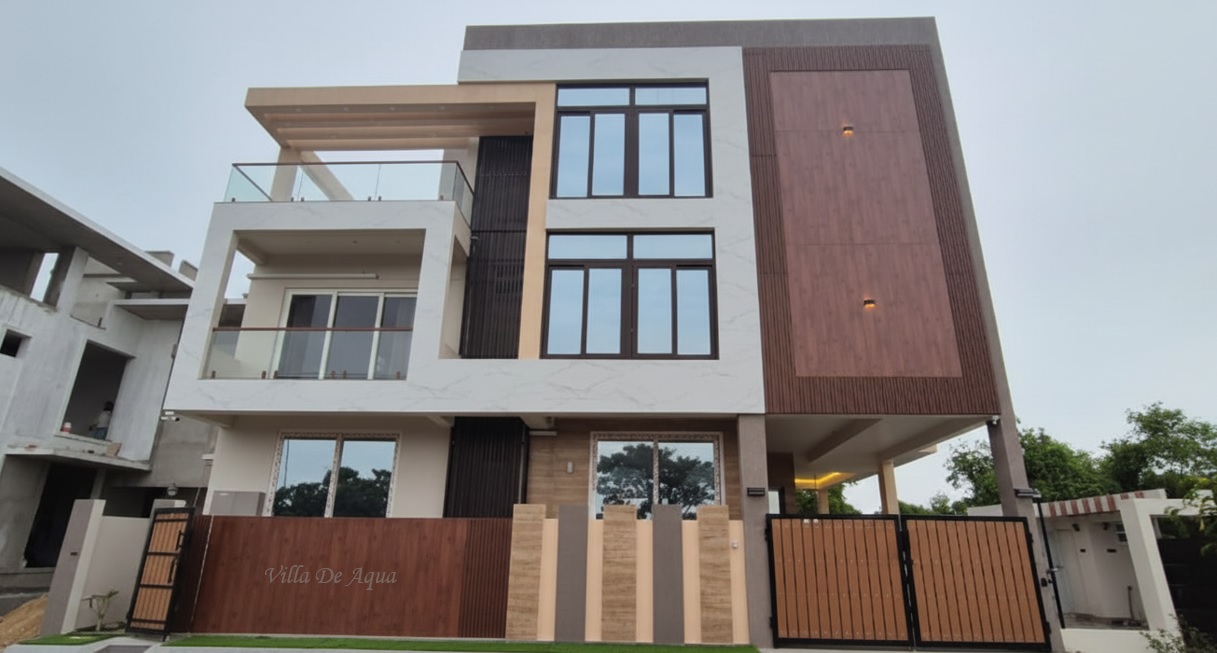 A modern multi-story villa featuring large glass windows, wooden accents, and balconies.